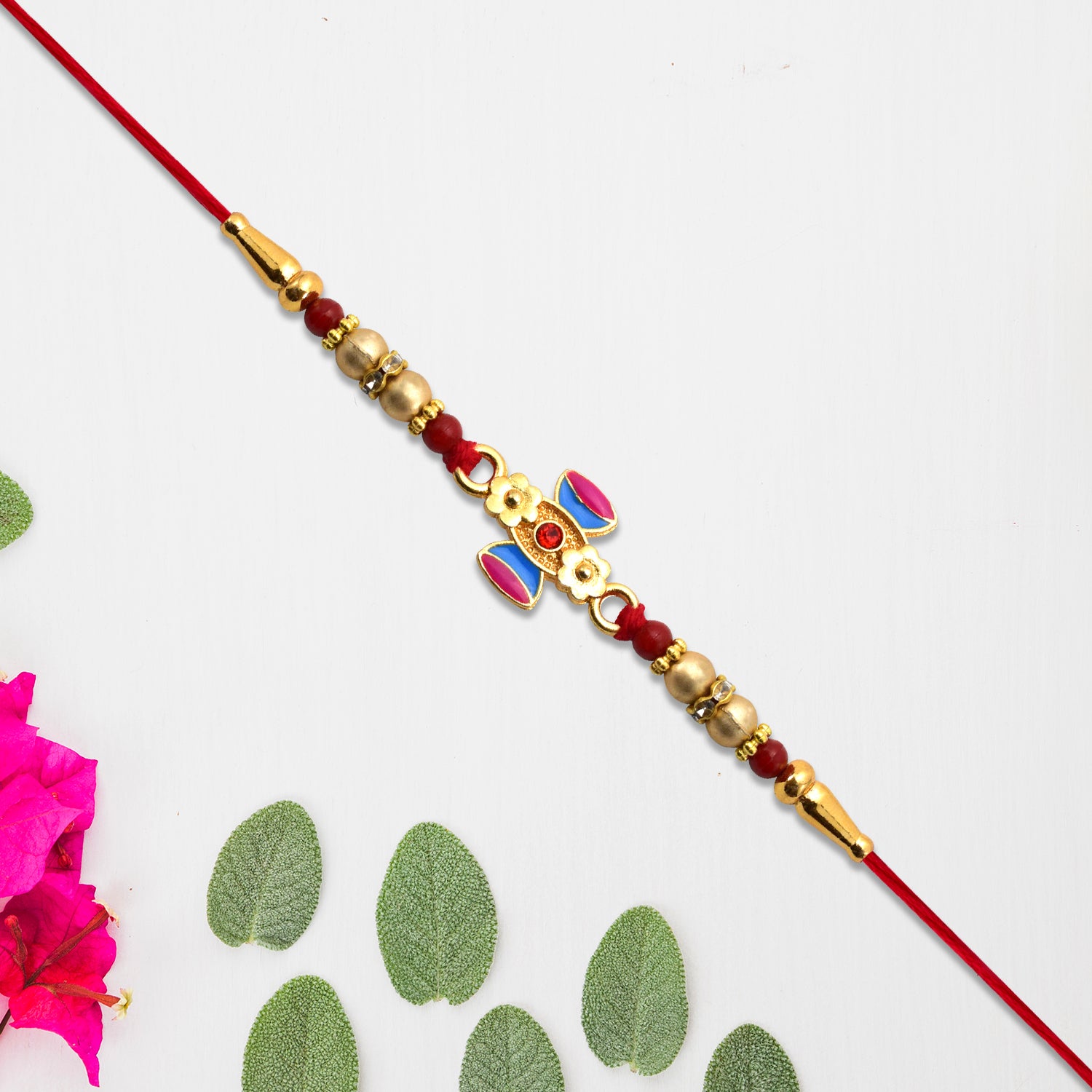 Damru Rakhi With Beads And Floral Detailing Damru Rakhi With Beads And Floral Detailing